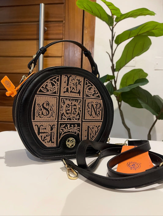 Black round bag with gift card and bag
